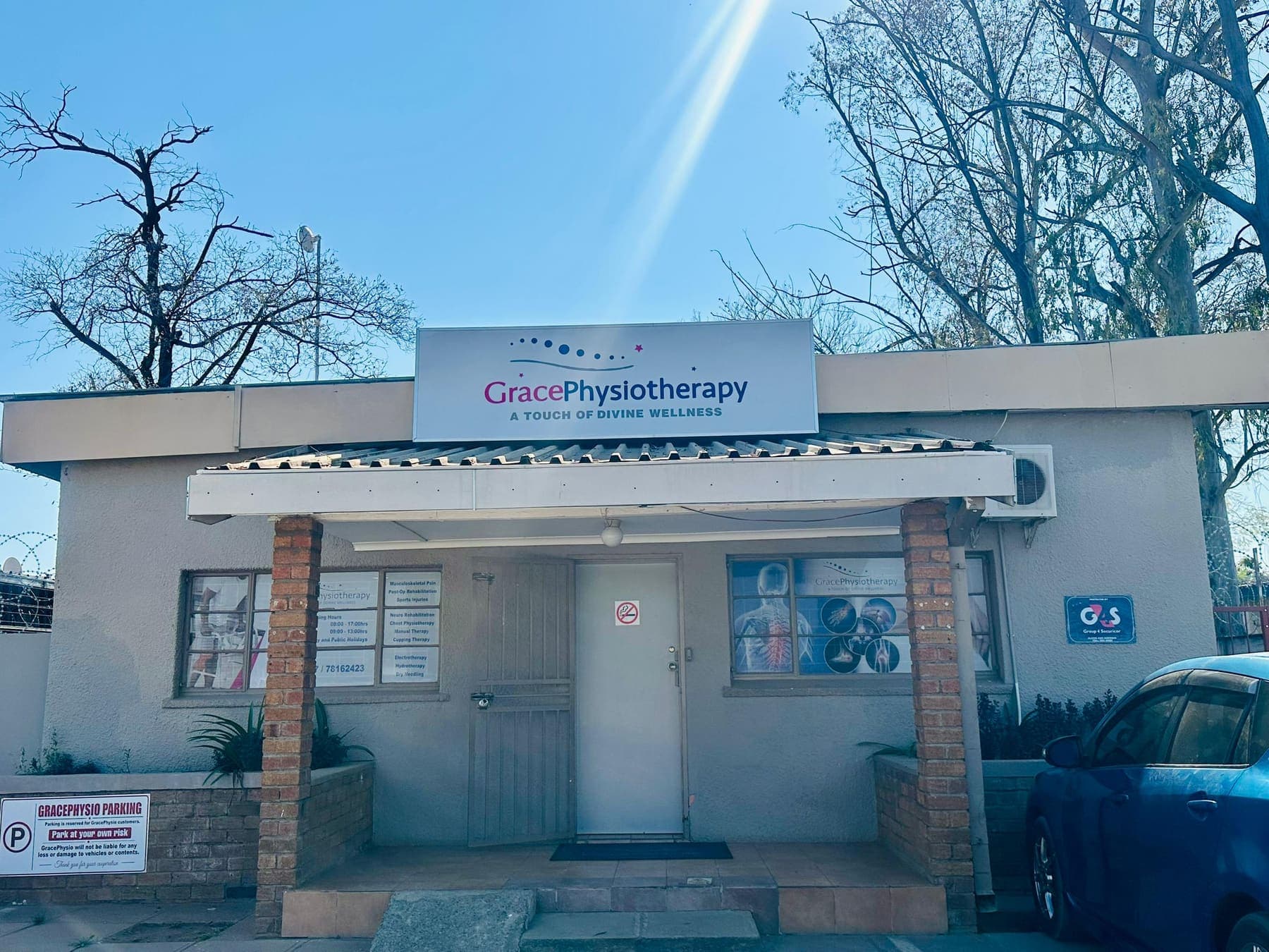 The Grace Physiotherapy building on Kaunda Road, Extension 2, with the practice's sign above the entrance and patient parking outside.