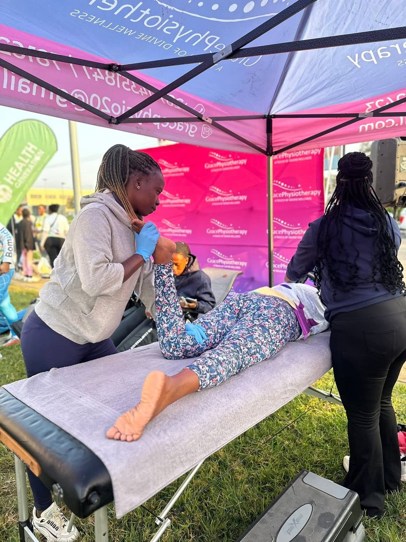 A Grace Physiotherapy therapist treating a young child on a treatment table, with a parent close by.