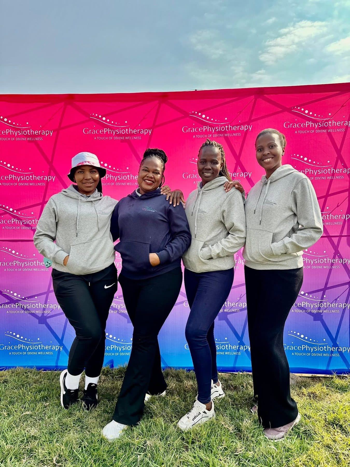 Four members of the Grace Physiotherapy team outdoors at a community event.