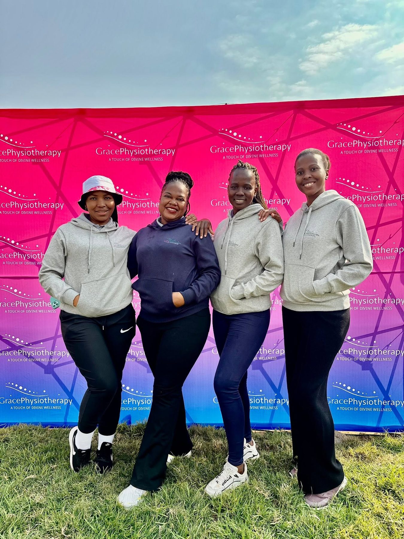 Four members of the Grace Physiotherapy team outdoors at a community event.