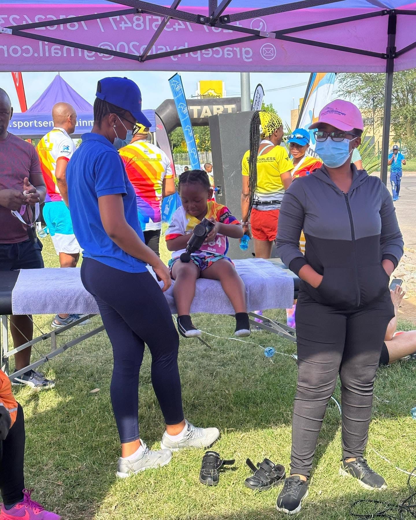 Grace Physiotherapy therapists preparing a treatment plan with a patient at an event recovery station.