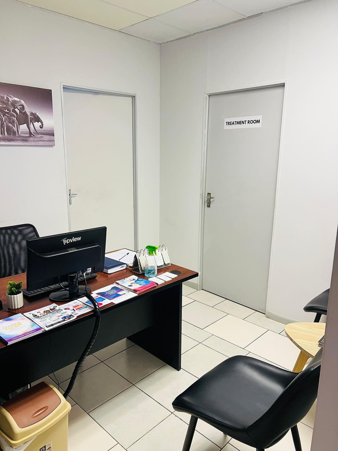 The front office at Molapo Crossing, with the treatment room door on the right and seating for waiting patients.