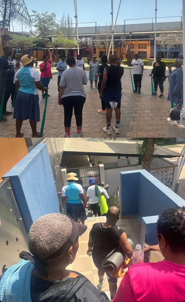 A community exercise circle led by Grace Physiotherapy in an outdoor courtyard in Gaborone.